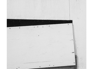 Construction Site Boarded Wall (black and white photograph)
