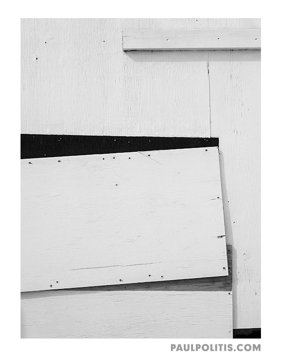 Construction Site Boarded Wall (black and white photograph)